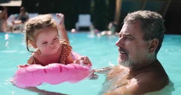 Opa Zwemt Samen Met Zijn Kleindochter Een Zwembad Een Opblaasbaar — Stockvideo