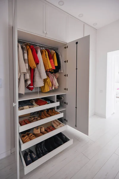 内置式衣柜 白色房间里有挂着的外套 衣服和鞋柜架 — 图库照片