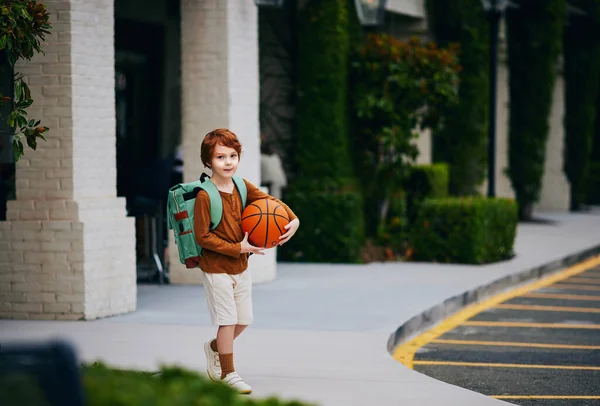 Cute Redhead School Boy Kid Basketball Backpack Walks Street — Zdjęcie stockowe