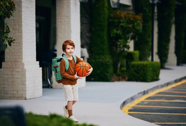 Cute Redhead School Boy Kid Basketball Backpack Walks Street Imagem De Stock