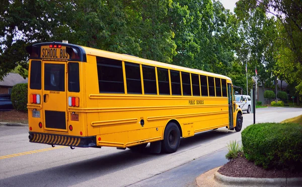 school bus is moving on the road in the morning