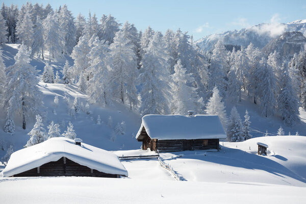 Winter mountain landscape with snowcapped hut