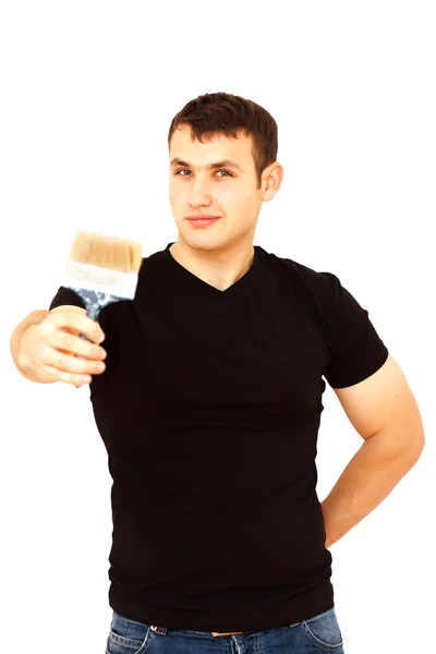 Joyful young man with a paint brush in his right hand — Stock Photo, Image