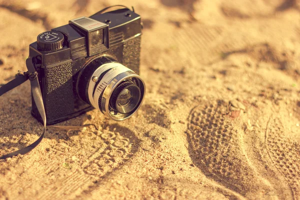 Retro camera on sand