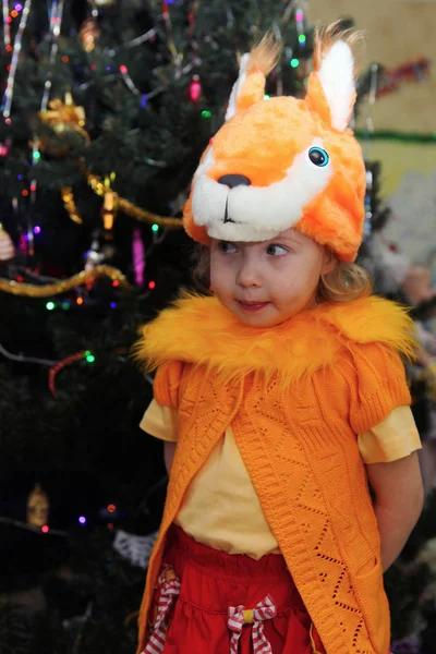 Meisje in een masker met een kerstboom eekhoorns — Stockfoto