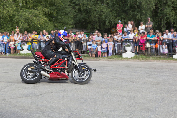 Motorcycle show in village Verkhovazhye, Vologda Region, Russia. Alexei Kalinin motorcycle accelerates