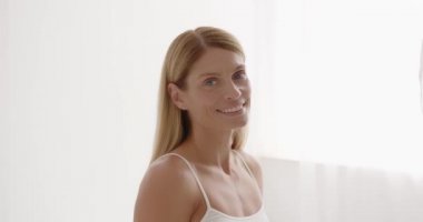 Senior positive lady close up portrait.Beautiful gorgeous 50s mid aged mature woman looking at camera isolated on white.Healthy face skin care beauty, middle age skincare cosmetics cosmetology concept