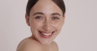 Headshot portrait of gorgeous happy woman looking at camera and enjoying of her face isolated on white. Lifting anti wrinkle skin care, spa concept. High resolution 