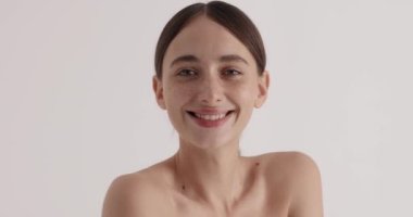 Calm serene young woman relaxing after taking shower at home. Female enjoying of her soft skin. Beauty treatment concept