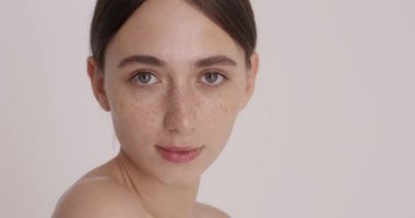 Portrait of beautiful woman with clean fresh hydrated skin after the shower. Positive facial expressions. Cosmetology, beauty and spa concept 