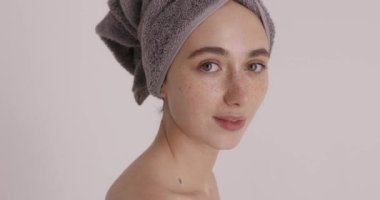 Cool offer in spa. Skin care beauty woman wearing hair towel after beauty treatment isolated on white background. Girl doing beauty procedures and anti-aging treatment at home 