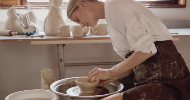 女陶工在陶工轮上用陶器工具塑造粘土产品 裁剪了视图 手工艺工厂真实和业余爱好的概念 — 图库视频影像