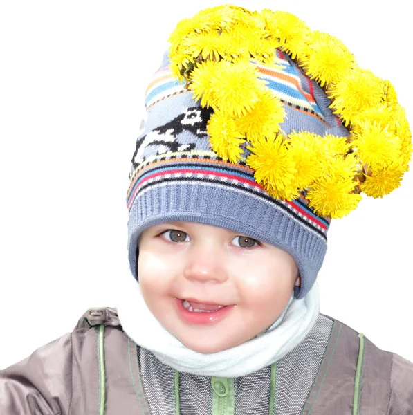 Portrait of a smiling boy in a wreath of dandelions Stock Image