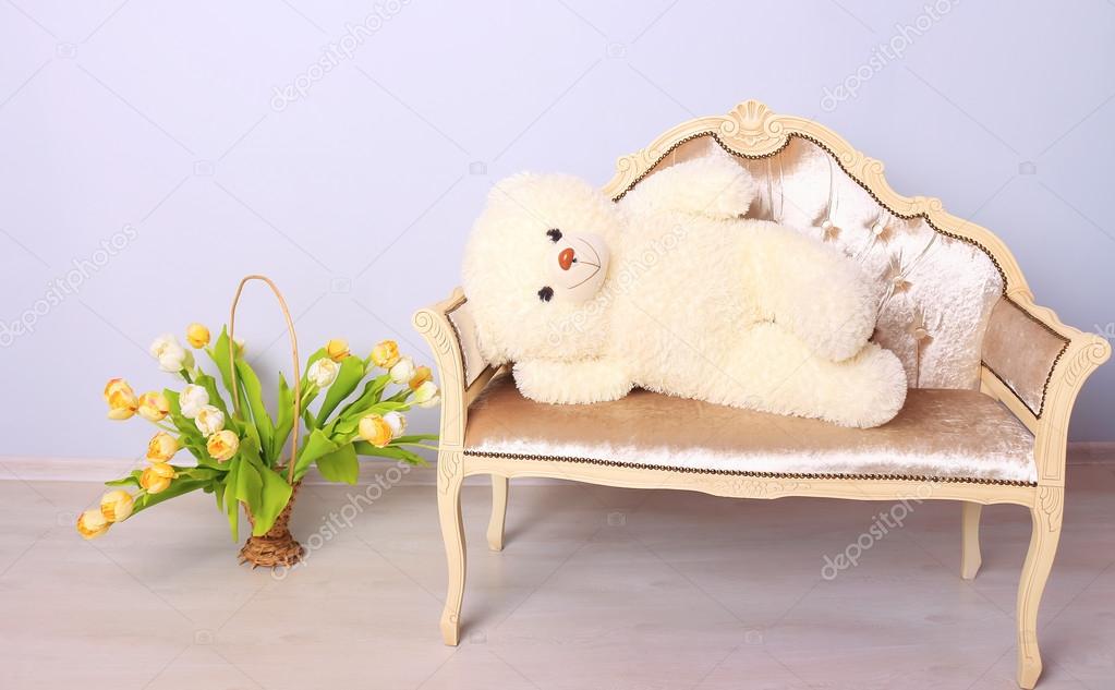 Teddy bear lying on a bench