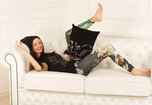 Young woman on a sofa — Stock Photo, Image