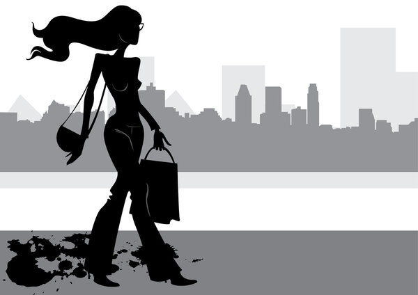 Silhouette fashion girl with flowing hair in a bag in his hand, against the background of the city