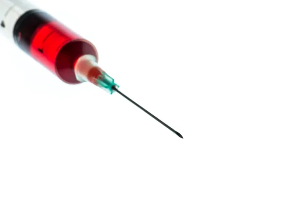 Needle and syringe containing red liquid — Stock Photo, Image