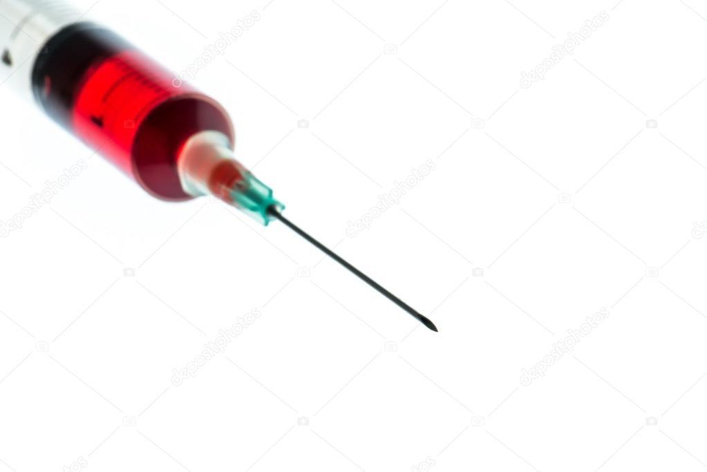 Needle and syringe containing red liquid