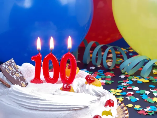 Birthday cake with red candles showing Nr. 100 Stockbild