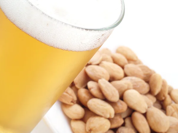 Appetizer with beer and fried, peeled almonds. — Stock Photo, Image