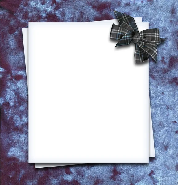 Paper blank with bow in corner on velvet fabric — Stock Photo, Image