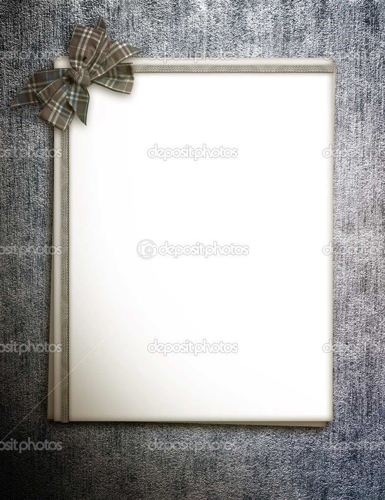 Paper blank with bow in corner on grunge background