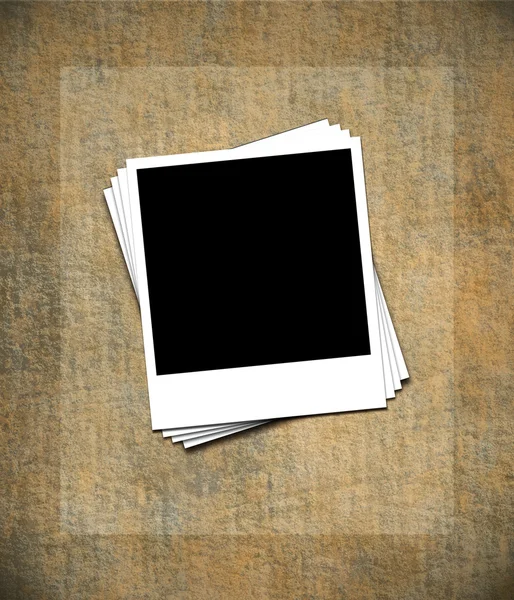 Blank photo frames on grunge wall — Stock Photo, Image