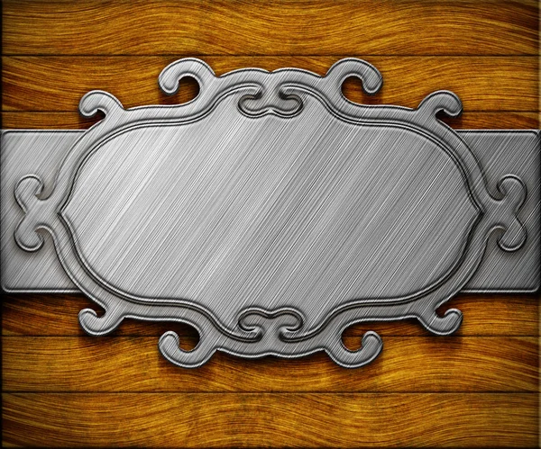 Moldura de metal ornamentado na parede de madeira — Fotografia de Stock