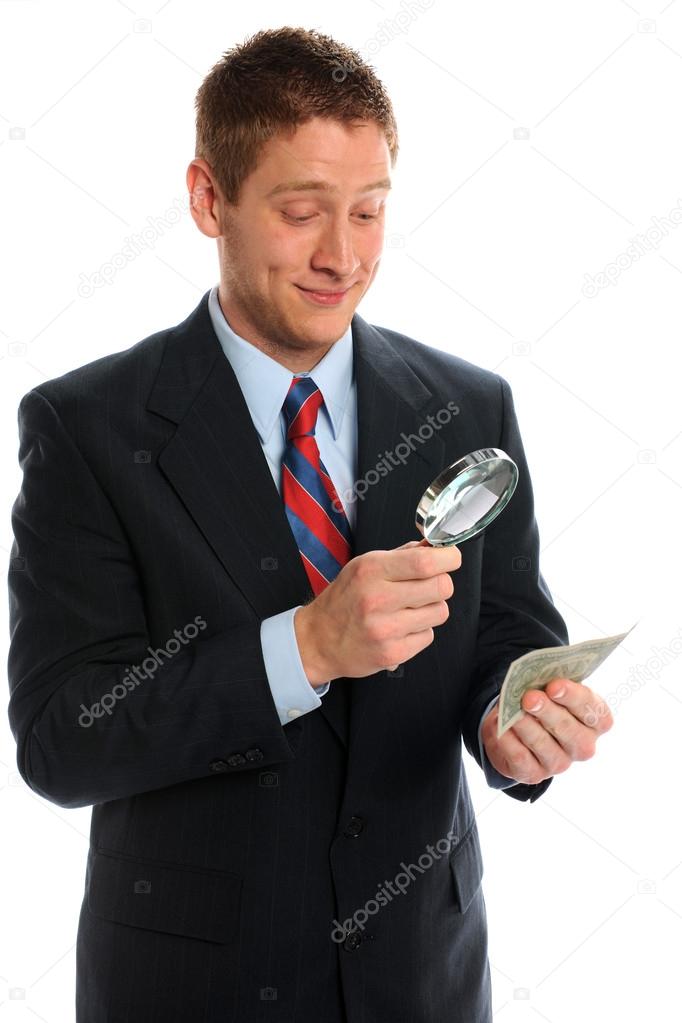 Bussiness Man Looking At Money Magnifying Glass