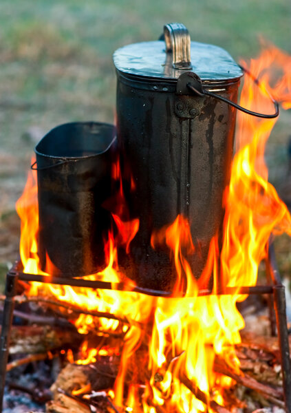 Kettles over campfire