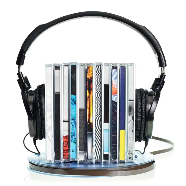 Headphones on stack of CDs and a reel tape — Stock Photo, Image