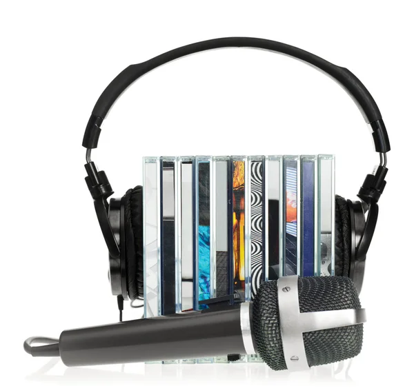 Headphones on stack of CDs with microphone — Stock Photo, Image