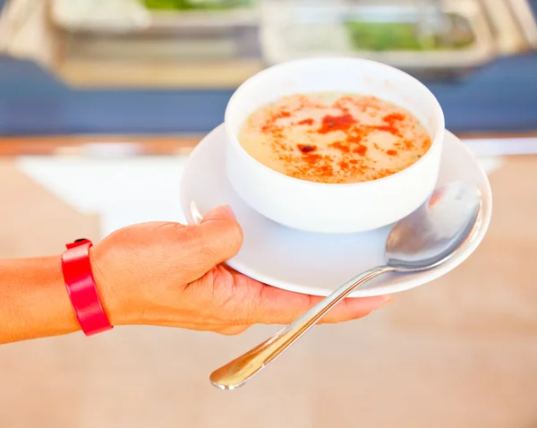Hand holding soup