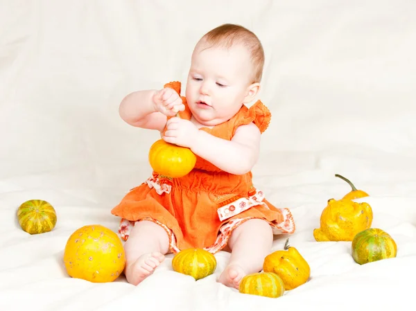 Infant with pumpkins — Stock Photo, Image