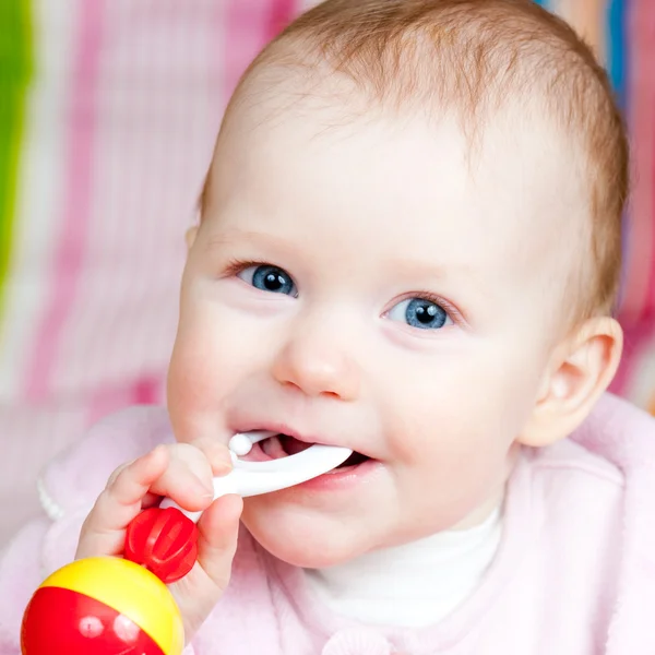 Infant with rattle — Stock Photo, Image