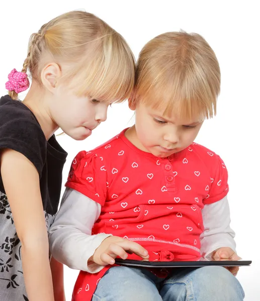 Girls playing with a tablet computer — Stock Photo, Image