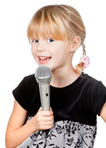 Child with microphone singing Stock Photo