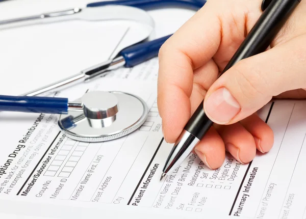 Hand with pen over Rx patient info — Stock Photo, Image