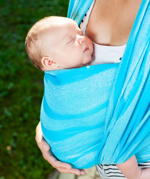 Woman with newborn baby in sling — Stock Photo, Image