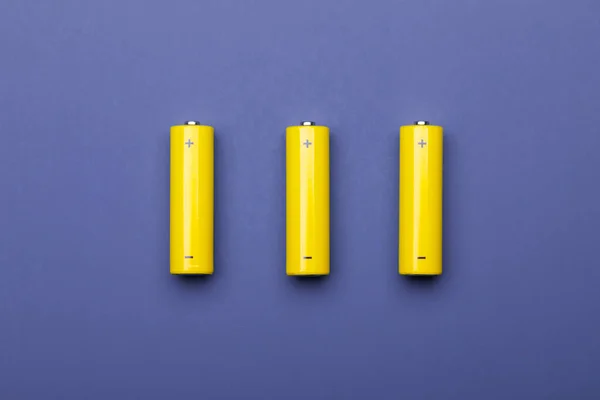 Top View Three Yellow Alkaline Batteries Nimh Rechargeable Cells Blue — Stock Photo, Image