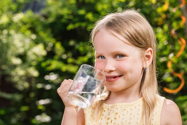 Happy Little Girl Wearing Yellow Dress Holding Glass Cup Water — Stock Photo, Image