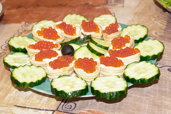 Appetizers with red caviar and a cucumbe — Stock Photo, Image