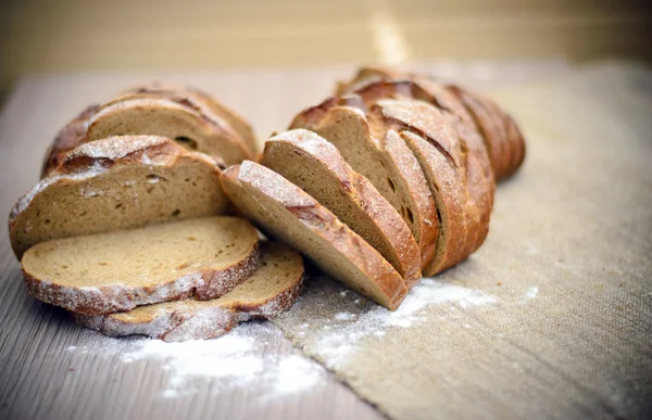 Frisches, schmackhaftes Brot auf holzigem Hintergrund — Stockfoto