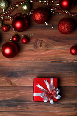 Hediyelik hediye kutusunun yakın plan görüntüsü. Altın kurdele yayı ile sarılmış. Öndeki parlak, parlak ahşap masaya yerleştirilmiş..