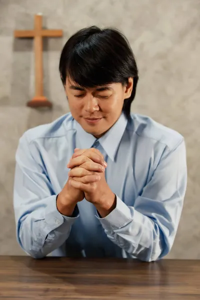 アジア人男性は聖書に頭を下げて十字架を背負ったのです キリスト教の信仰によると イエスの救いです 神の加護を祈れ コンセプト祈り願い — ストック写真