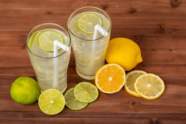 Two Refreshing Glasses Cold Fruit Juice Straw Ice Lime Lemon — Stock Photo, Image