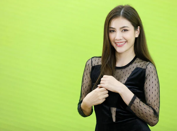 Portrait of Asian woman in black see through dress standking and pose with friendly positive smile face. Concept Beautiful and confident working woman
