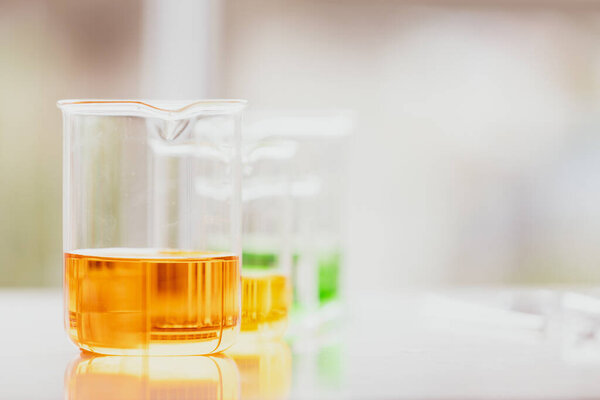 Colorful water and liquid in beager and test tube in laboratory