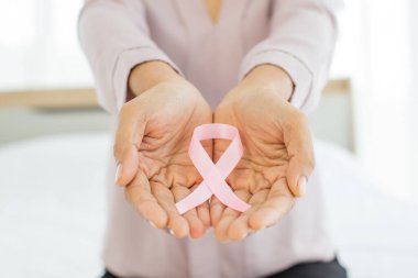 Pembe kurdele, hastalıktan kurtulan kadın eli göğüs kanserinin uluslararası kumaş sembolünü temsil ediyor. Göğüs kanserine karşı moral desteği veriyor ve göğüs tümörüyle savaşmaya istekli olduğunu ifade ediyor.