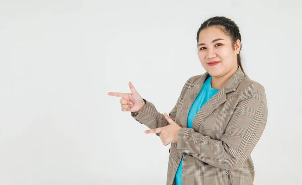 Lively Asian woman confidently pointing fingers to mark exactly correct direction and remarkable guide recommended to fire target. Business girl gesture as shooting goal and aiming focused attention.